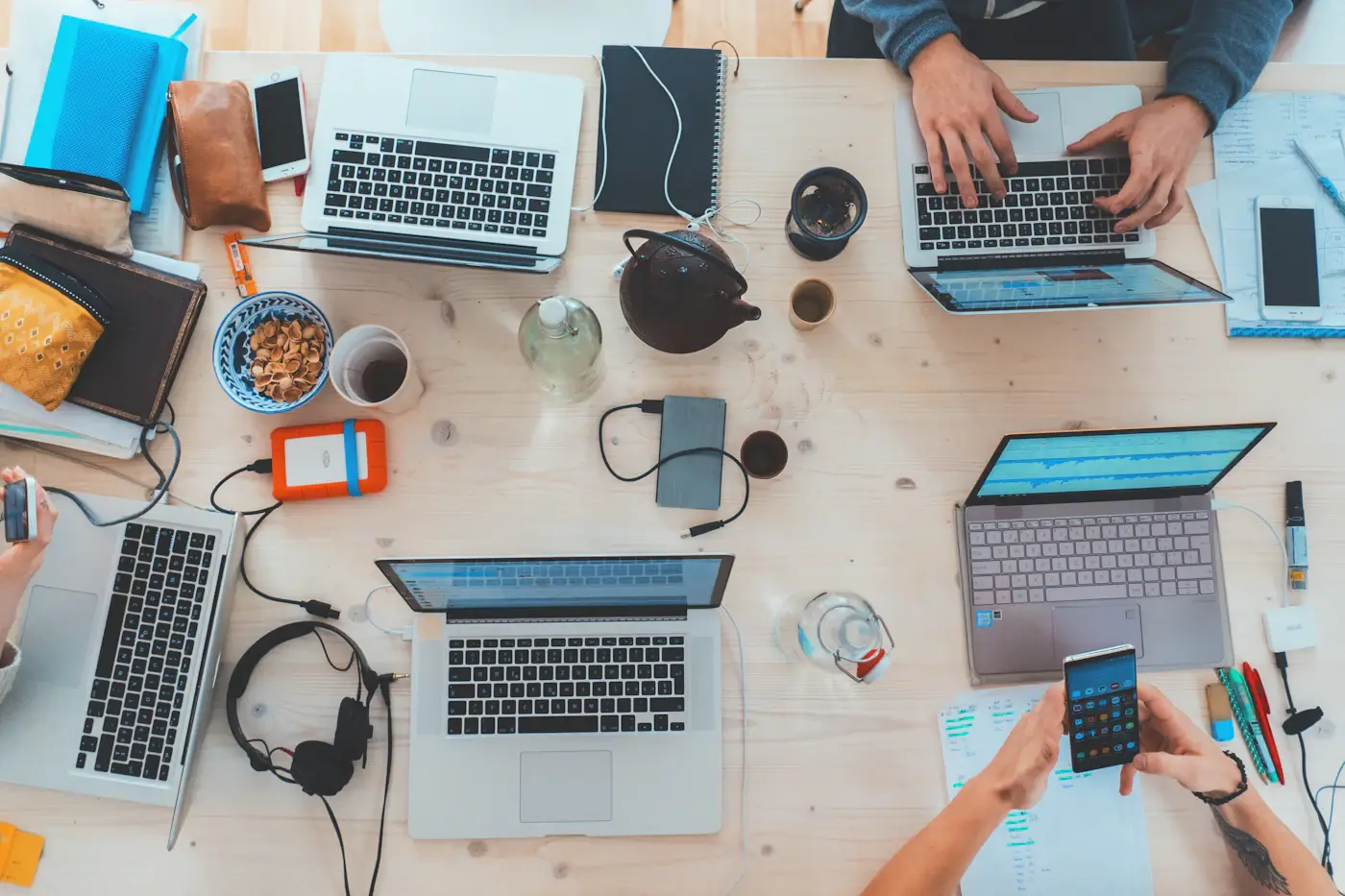 Team working with laptops at a shared desk
